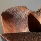 Close-up of burned and brushed walnut wood texture on sculptural vase