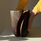 Handmade walnut wood vase shown in hands to display scale and craftsmanship