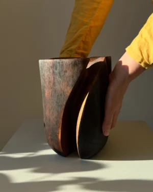 Handmade walnut wood vase shown in hands to display scale and craftsmanship