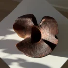 Top view of sculptural walnut wood vase with organic carved opening