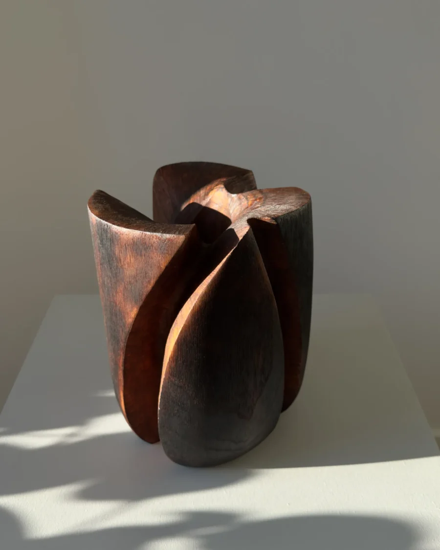 Sculptural walnut wood vase with organic asymmetrical form and brushed burned texture