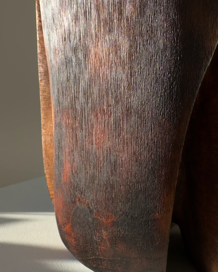 Solid walnut vase with fire-charred finish and tactile brushed texture