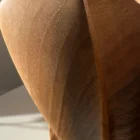 threefold-balance-organic-walnut-form-closeup-smooth-surface Close up detail of walnut wood grain and hand carved texture on abstract sculpture