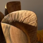 threefold-balance-walnut-wood-detail-texture close up of walnut wood grain on hand carved sculpture, natural texture and organic surface detail
