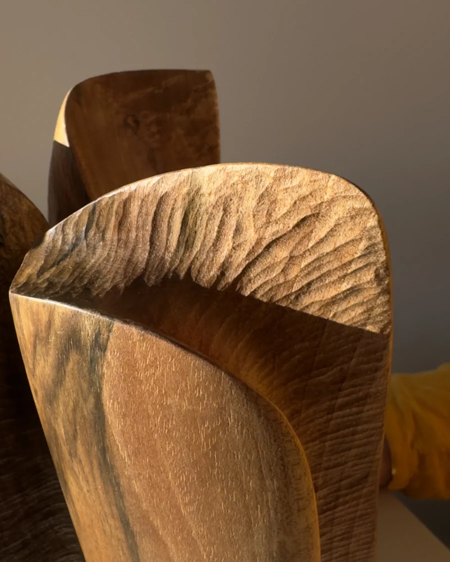threefold-balance-walnut-wood-detail-texture close up of walnut wood grain on hand carved sculpture, natural texture and organic surface detail