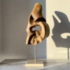 through-the-light-walnut-form-travertine-base Walnut wood abstract sculpture mounted on travertine stone base with brass rod connection
