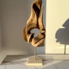 through-the-light-walnut-wood-sculpture-front-view Through the Light hand carved walnut wood sculpture on travertine base in warm natural sunlight