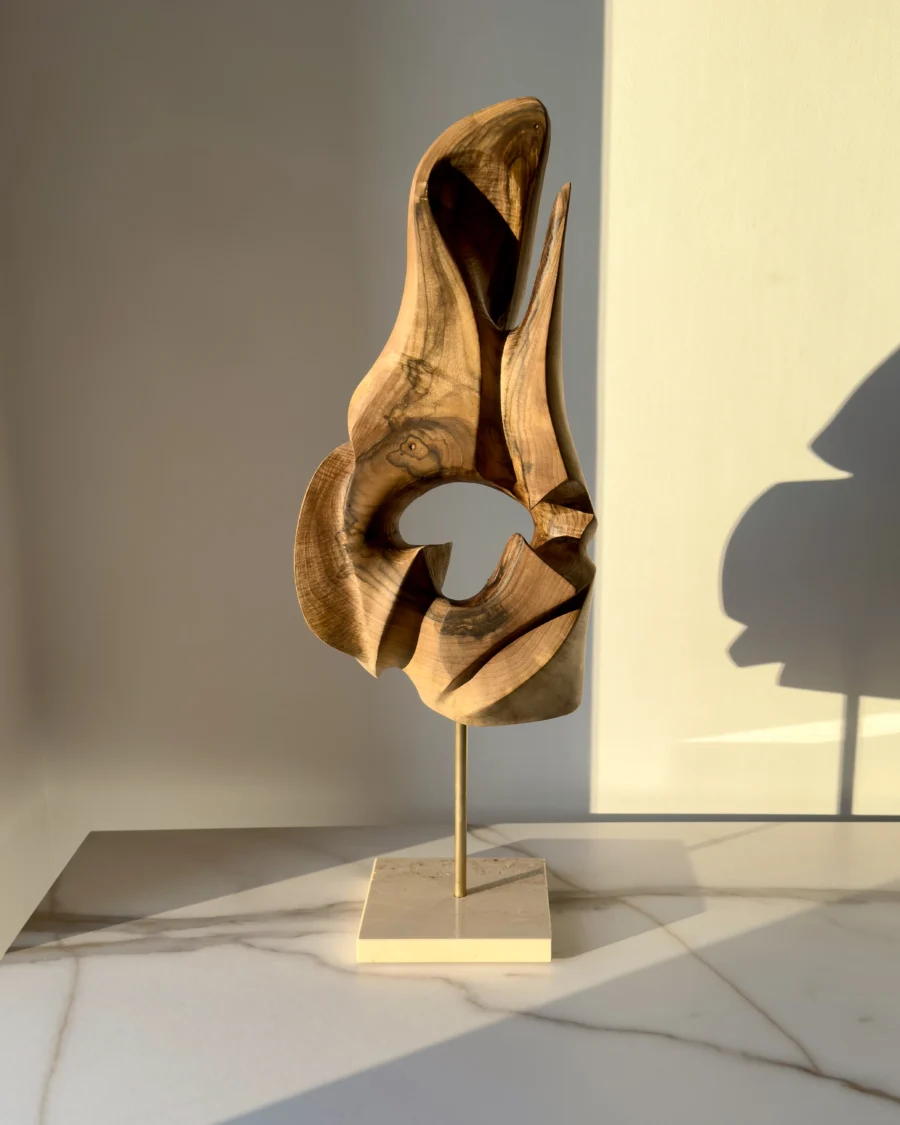 through-the-light-walnut-wood-sculpture-front-view Through the Light hand carved walnut wood sculpture on travertine base in warm natural sunlight