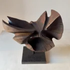 trace-of-fire-side-angle-walnut-sculpture Abstract walnut wood sculpture “Trace of Fire” photographed from the front with asymmetrical organic wings and natural cracks.