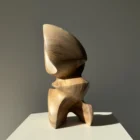 Back view of Aureon walnut wood sculpture with an open base, flowing lines and natural variations in the wood.