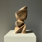 Aureon abstract walnut sculpture shown in natural light, with a calm vertical presence and softly carved organic shape.