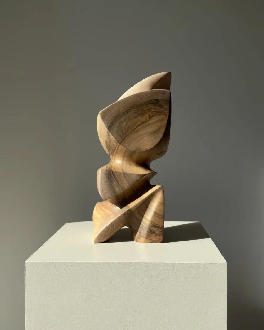 Aureon abstract walnut sculpture shown in natural light, with a calm vertical presence and softly carved organic shape.