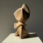 Aureon abstract walnut sculpture shown in natural light, with a calm vertical presence and softly carved organic shape.