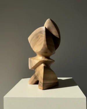 Aureon abstract walnut sculpture shown in natural light, with a calm vertical presence and softly carved organic shape.