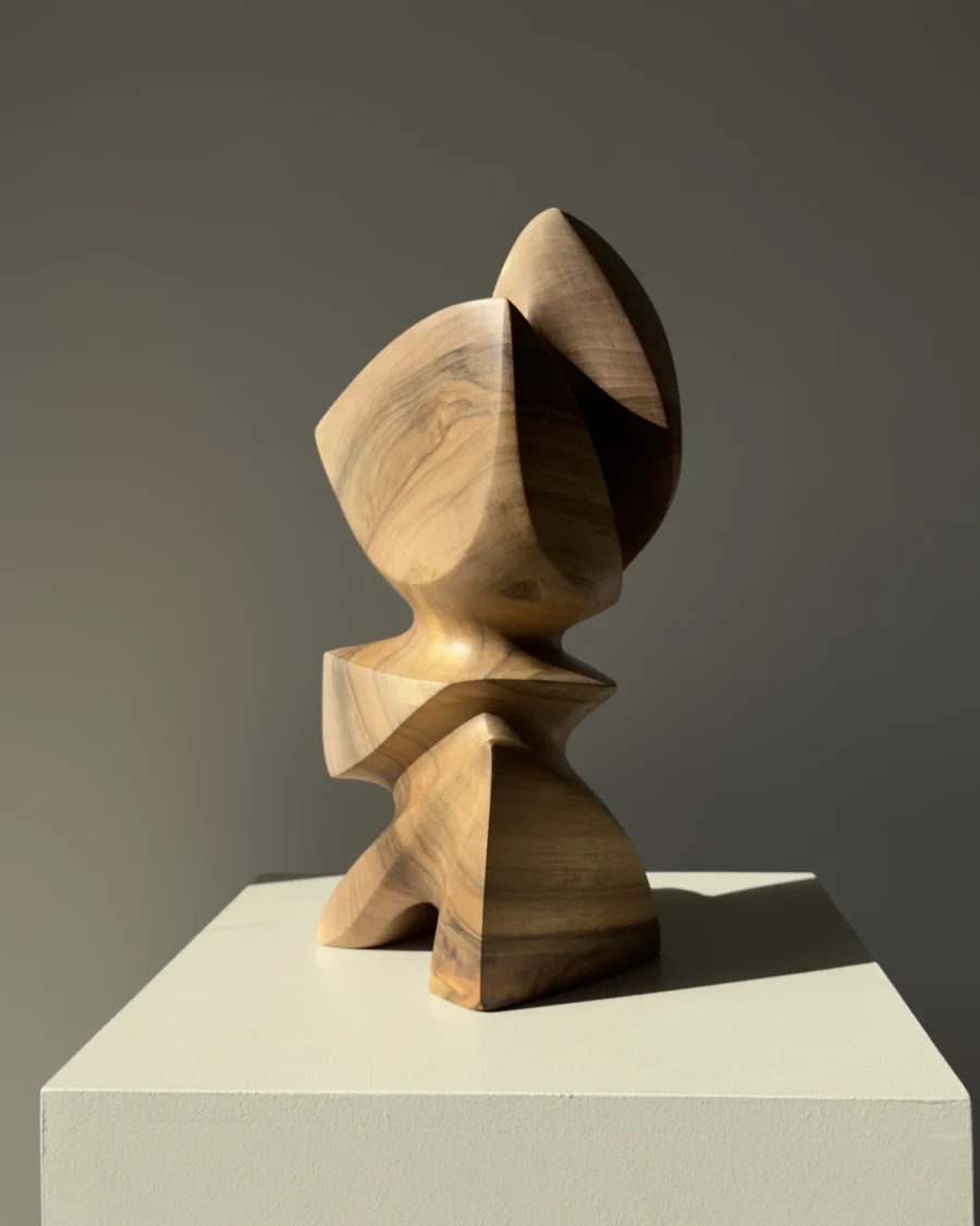 Aureon abstract walnut sculpture shown in natural light, with a calm vertical presence and softly carved organic shape.