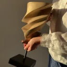 The artist holding Breath of Fire, a one-of-a-kind hand-carved walnut wood sculpture