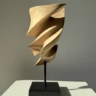 Breath of Fire walnut wood sculpture in natural sunlight within a contemporary interior setting