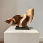 confluence-hand-carved-walnut-wood-sculpture-hero Confluence hand-carved walnut wood sculpture on a black granite base photographed in natural light.
