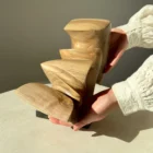 confluence-organic-walnut-wood-sculpture-scale-photo-4 Side view of Confluence walnut wood sculpture shown in hands highlighting its flowing organic form.