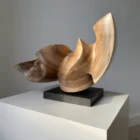 confluence-walnut-sculpture-closeup-black-granite-base Front view of Confluence abstract walnut wood sculpture on a black granite base.