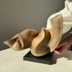 confluence-walnut-sculpture-side-view-in-hands-2 Confluence hand-carved walnut wood sculpture shown with hands to illustrate scale and proportions.