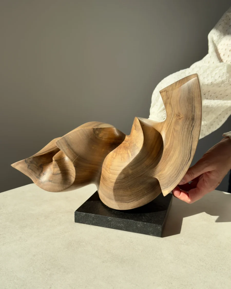confluence-walnut-sculpture-side-view-in-hands-2 Confluence hand-carved walnut wood sculpture shown with hands to illustrate scale and proportions.