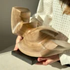 confluence-walnut-wood-sculpture-in-hands-front-view-1 Confluence hand-carved walnut wood sculpture shown in hands to demonstrate scale.