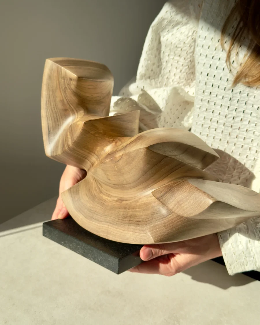 confluence-walnut-wood-sculpture-in-hands-front-view-1 Confluence hand-carved walnut wood sculpture shown in hands to demonstrate scale.