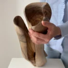 dualis-walnut-vase-held-in-hands Top view of the Dualis walnut vase revealing its sculpted interior and contrasting grain.