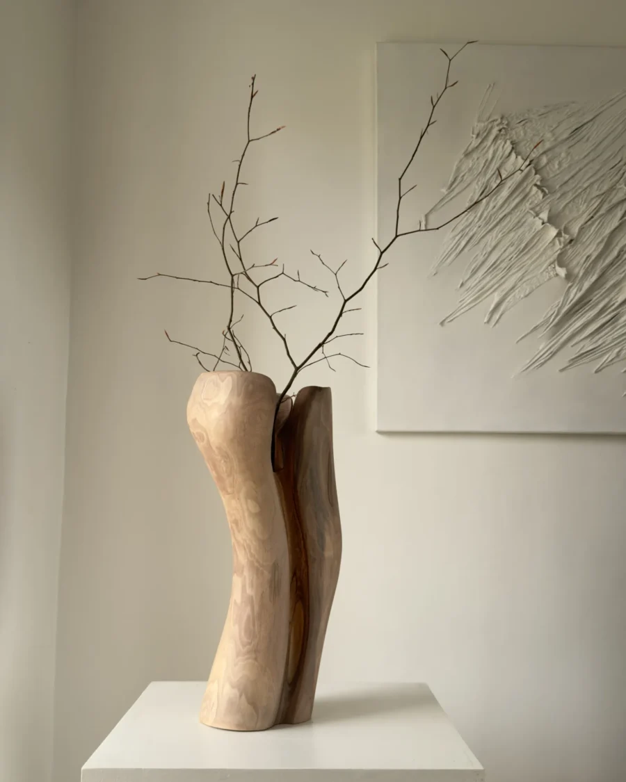 dualis-walnut-vase-side-view Side view of the Dualis walnut vase highlighting its organic carved form and natural wood grain.