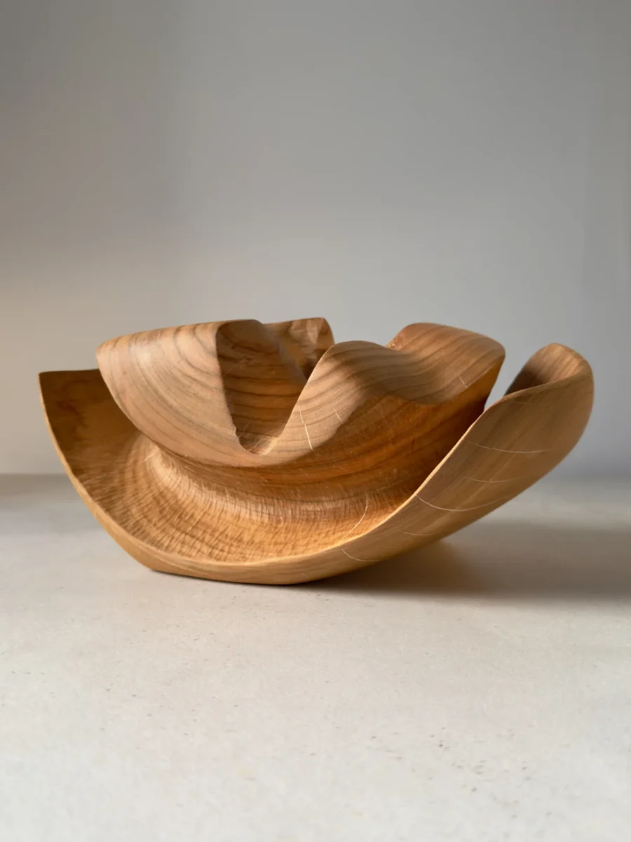 Side view of Memory Lines hand-carved cherry wood ikebana vase revealing layered organic forms