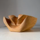 Hand-carved cherry wood ikebana vase Memory Lines showing flowing sculptural forms and natural grain patterns