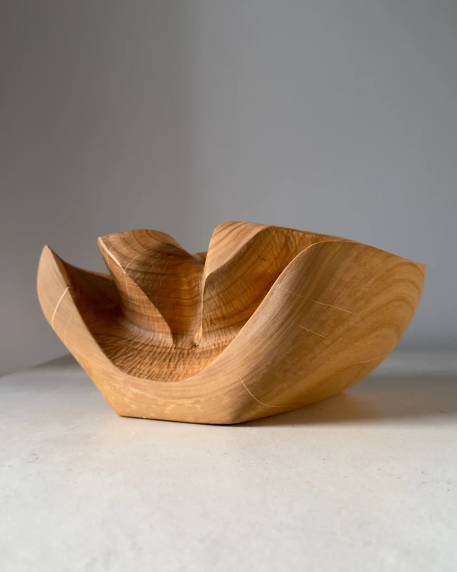 Hand-carved cherry wood ikebana vase Memory Lines showing flowing sculptural forms and natural grain patterns