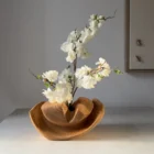 Memory Lines hand-carved cherry wood ikebana vase displayed with flowering branch in a contemporary interior