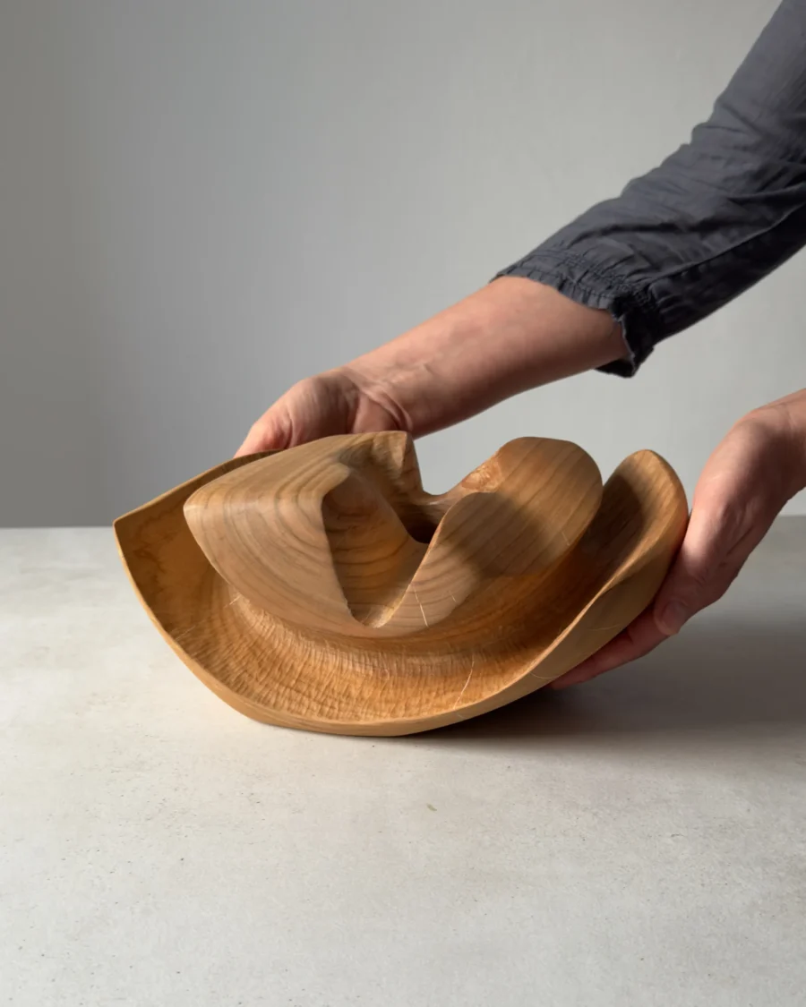 Hand-carved cherry wood ikebana vase shown in hands for scale and proportion reference