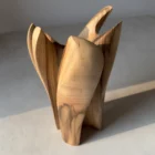 quiet-bloom-organic-modern-vase Side view of a hand carved walnut vase with layered petal-like forms