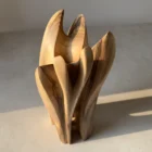quiet-bloom-walnut-vase-top-view Angled top view of organic walnut wood vase showing flowing carved contours