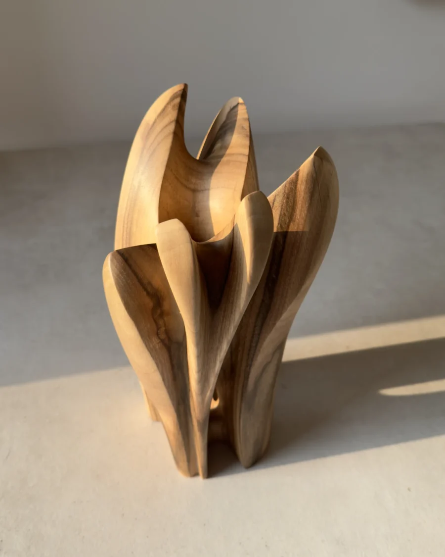 quiet-bloom-walnut-vase-top-view Angled top view of organic walnut wood vase showing flowing carved contours
