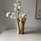quiet-bloom-walnut-wood-vase-dry-flowers Organic modern walnut wood vase with decorative branches and sculptural opening through the base