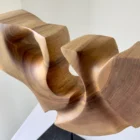 quiet-span-walnut-wood-sculpture-detail Close-up detail of Quiet Span hand-carved walnut sculpture showing smooth curves and natural wood grain.