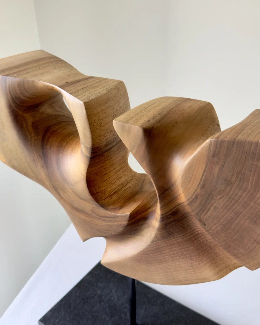 quiet-span-walnut-wood-sculpture-detail Close-up detail of Quiet Span hand-carved walnut sculpture showing smooth curves and natural wood grain.