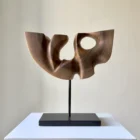 quiet-span-walnut-wood-sculpture-front Quiet Span hand-carved walnut wood sculpture viewed from the front on a black metal stand.