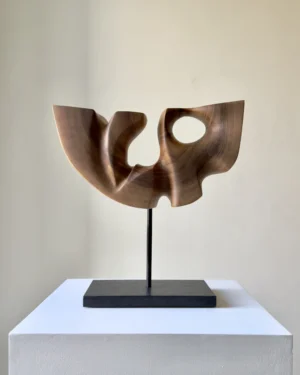 Quiet Span hand-carved walnut wood sculpture viewed from the front on a black metal stand.