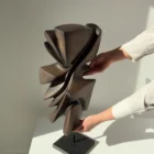 Profile view of Shaped by Silence showing flowing organic forms carved from solid apple wood.