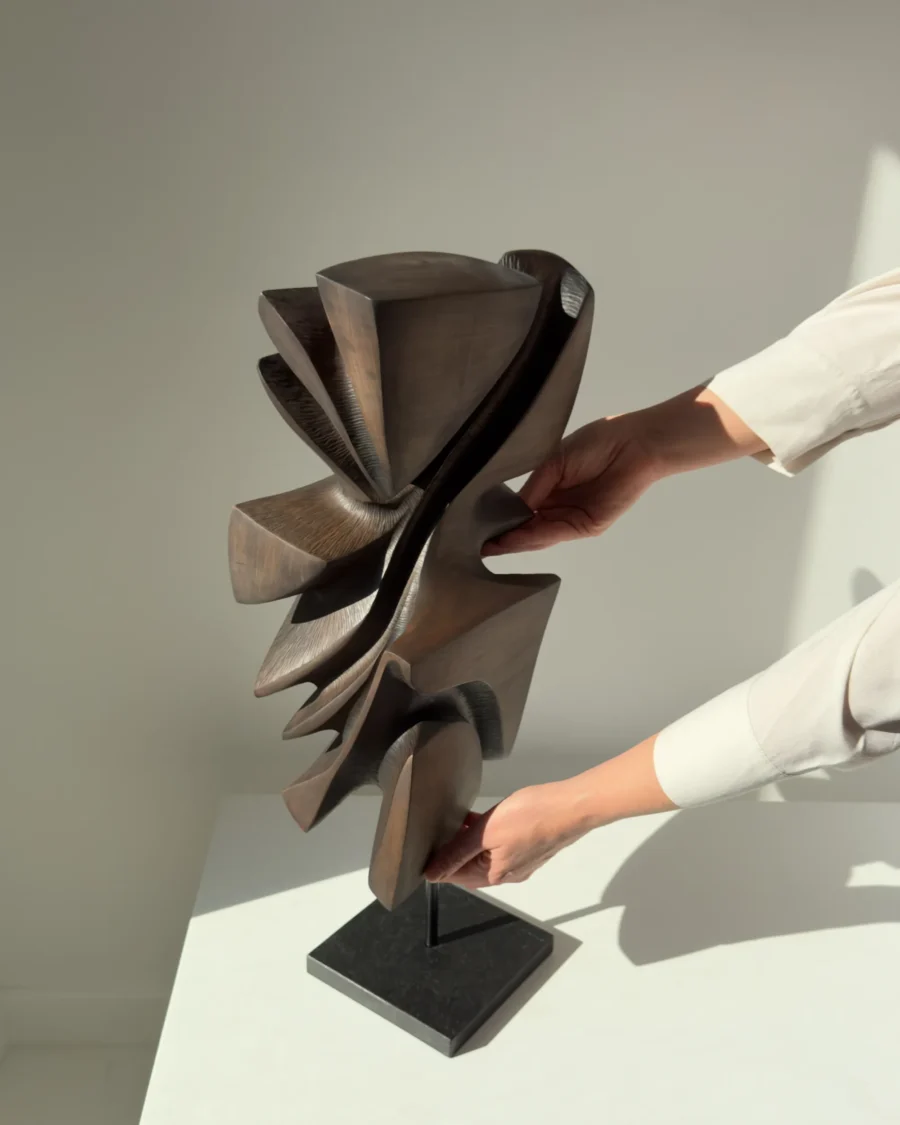 Profile view of Shaped by Silence showing flowing organic forms carved from solid apple wood.