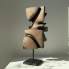 Rear view of Shaped by Silence sculpture revealing smooth planes and deep carved recesses.