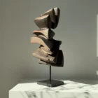 Side view of Shaped by Silence abstract apple wood sculpture showing layered organic forms and carved textures.