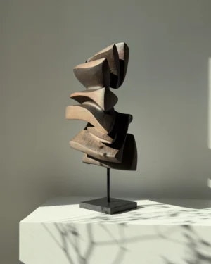 Side view of Shaped by Silence abstract apple wood sculpture showing layered organic forms and carved textures.