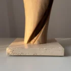 silent-axis-travertine-base-detail Detail of Silent Axis walnut sculpture showing spiral carving and natural travertine stone base