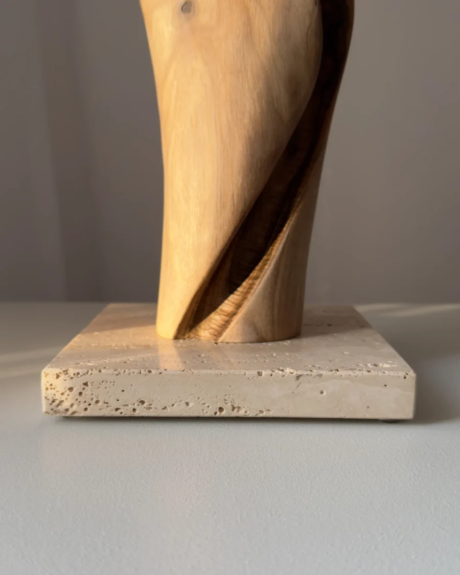 silent-axis-travertine-base-detail Detail of Silent Axis walnut sculpture showing spiral carving and natural travertine stone base